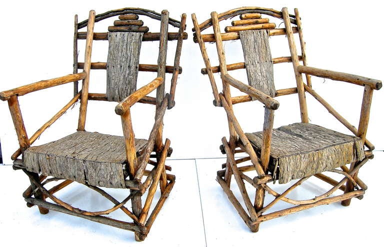 A terrific pair of vintage, hand made, Mic Mac Indian native chairs. Rustic in their simplicity, elegant in their design and aesthetic. Of native Maine elements, wood, bark and vine.