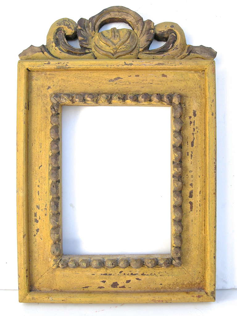 Terrific vintage hand-carved frame with a floral and scrollwork motif. Having vivid mustard yellow original paint and naive bead-work detailing.  A folk original.