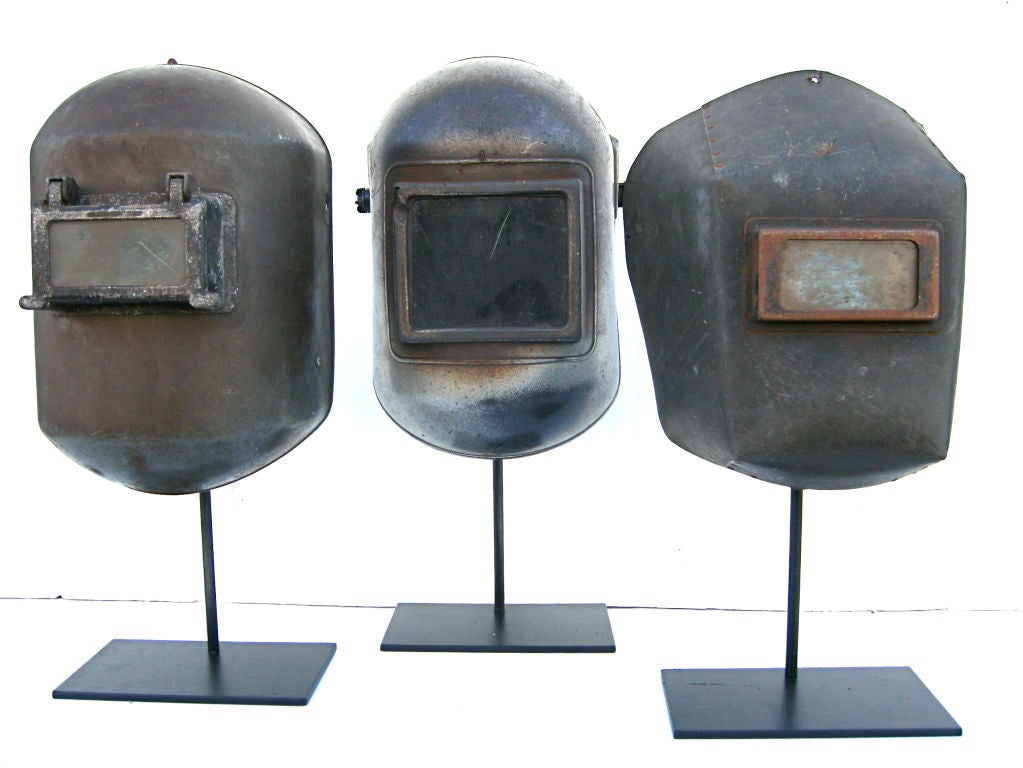 A graphic and expressive trio set of vintage welding masks. Visually appealing and highly graphic industrial sculptures.