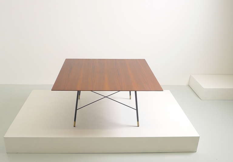 Ico Parisi , Italy , circa 1960 , walnut coffee table with light and elegant black base , the four legs secured by very slender cross braces , each leg capped with small brass foot .
Documented in 