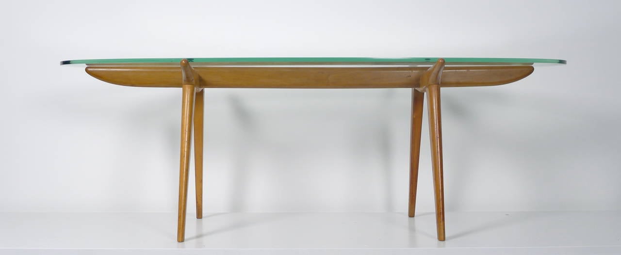 Italian 1950's Coffee Table , skeletal maple wood frame supporting the original thick glass top with nice green edge . This design manages to be elegant & minimal yet strong and sturdy .