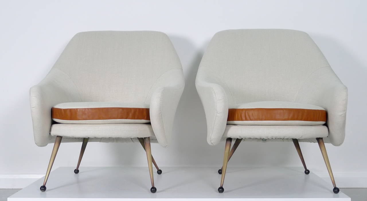 Marco Zanuso for Arflex, Italy, 1950s. A stunning pair of Martingala armchairs painstakingly reupholstered to the original specifications in linen with leather detailing. The chairs are named from the pleat to the back which has been matched exactly