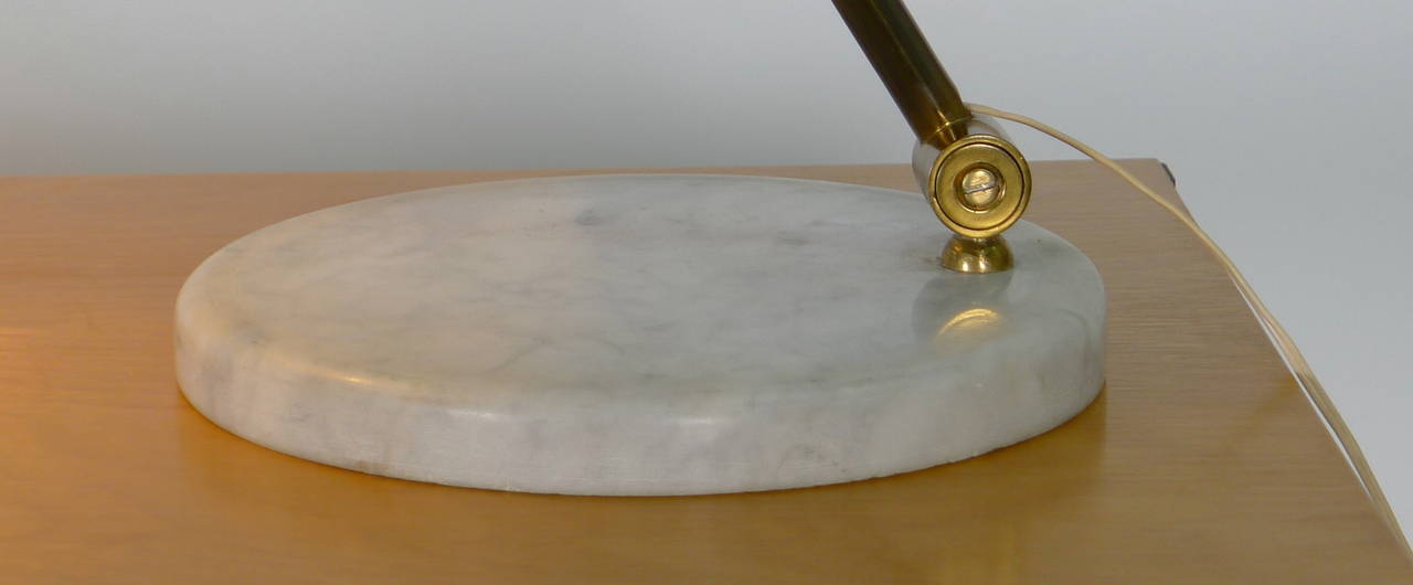 Excellent quality Italian desk lamp attributed to Stilnovo . Heavy circular marble base supporting brass arm which pivots at the base and the shade , latter painted in cream .