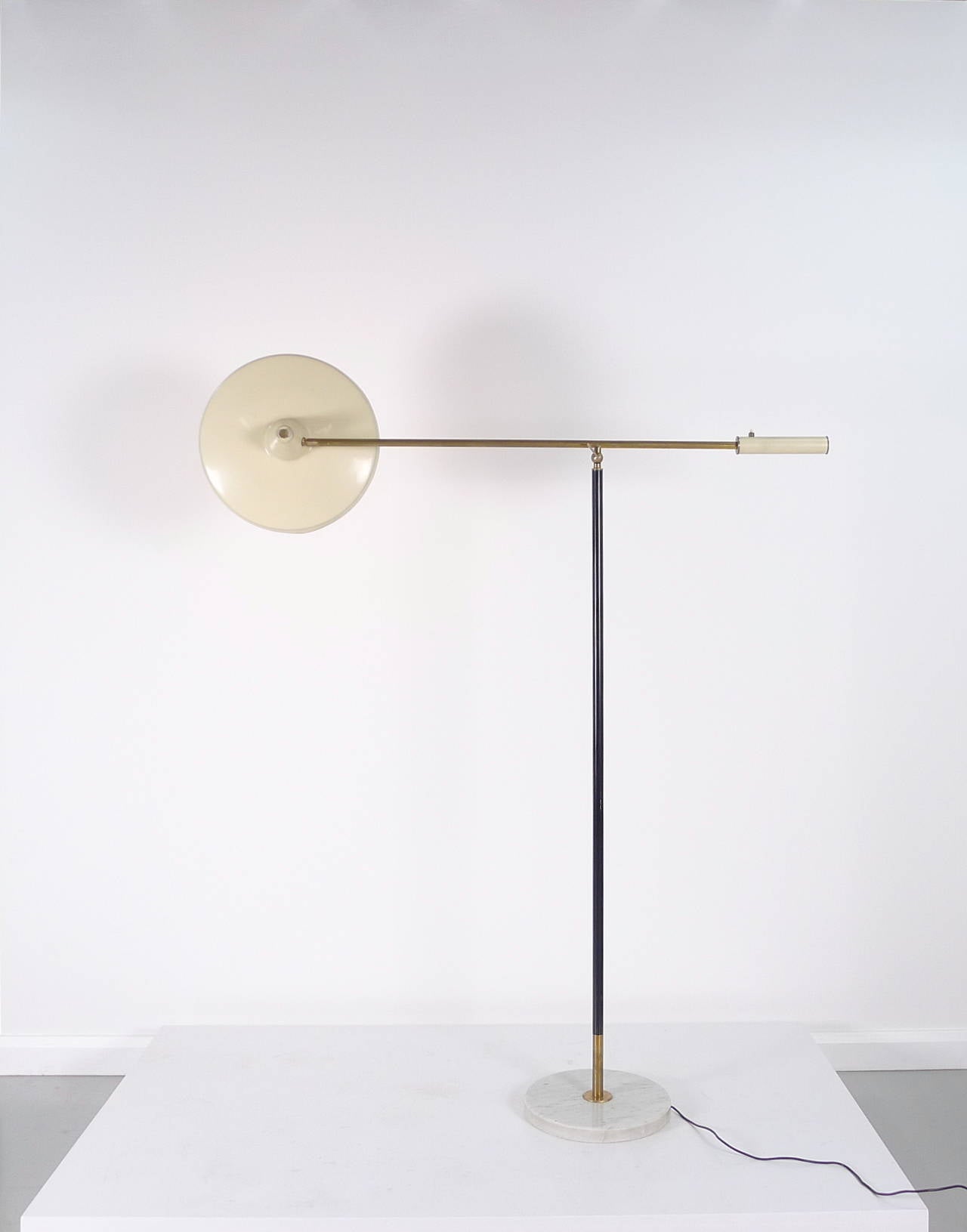 Stunning Stilnovo, Italy, floor lamp, 1950s. Marble base supporting enamelled and brass upright, pivoting arm above with counterbalance retaining switch to on end and shade to the other, shade to arm also a pivot point.

Lamp is signed with the