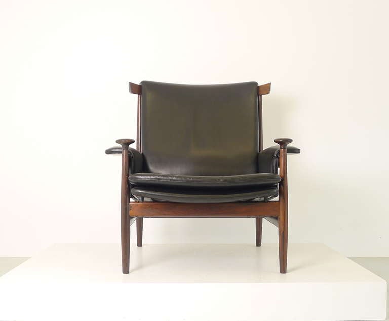 Finn Juhl for France and Sons, Denmark. A stunning black leather, solid Rosewood framed Bwana chair in perfect condition. Label and branded marks to underside.
