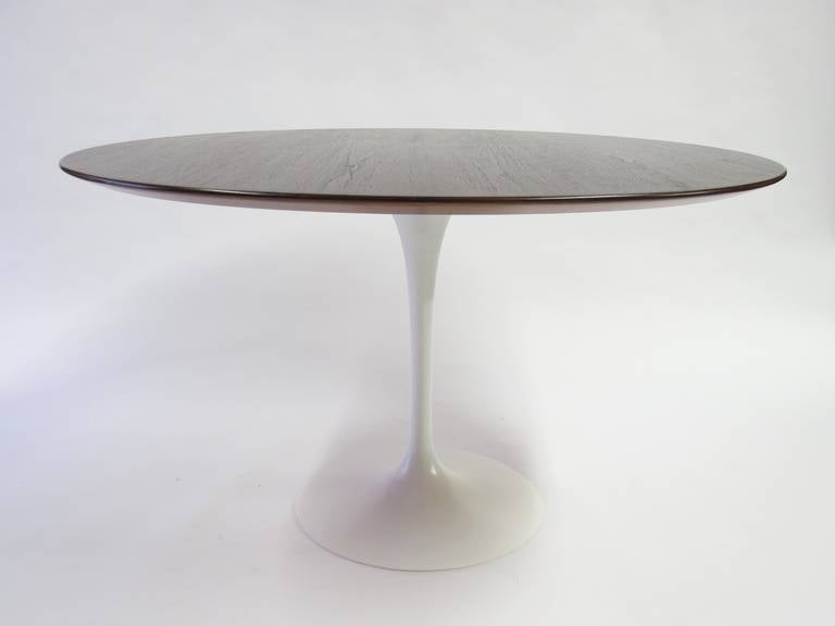 Eero Saarinen Tulip Dining Table by Knoll.
The Walnut top is 48”. The white enameled base is 28.5” tall.