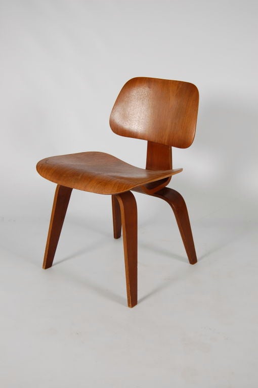 Charles and Ray Eames for Evans Products Company , a DCW ( Dining Chair Wood ) , moulded plywood with walnut veneer . This example is in stunning original condition with no scratches , chips or repairs , finish looks to be original and retains the