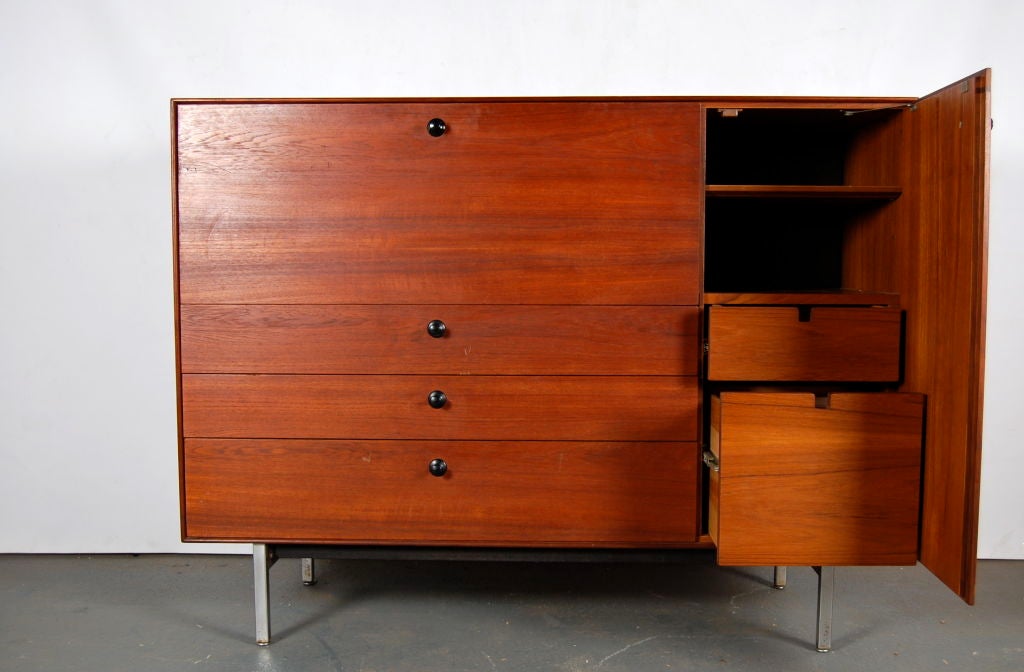 George Nelson for Herman Miller Walnut Thin Edge drop front secretary unit circa 1955 . Door to right reveals single shelf over pull out drawers , left side of three drawers beneath drop down desk top concealing small five drawer thin edge jewelry