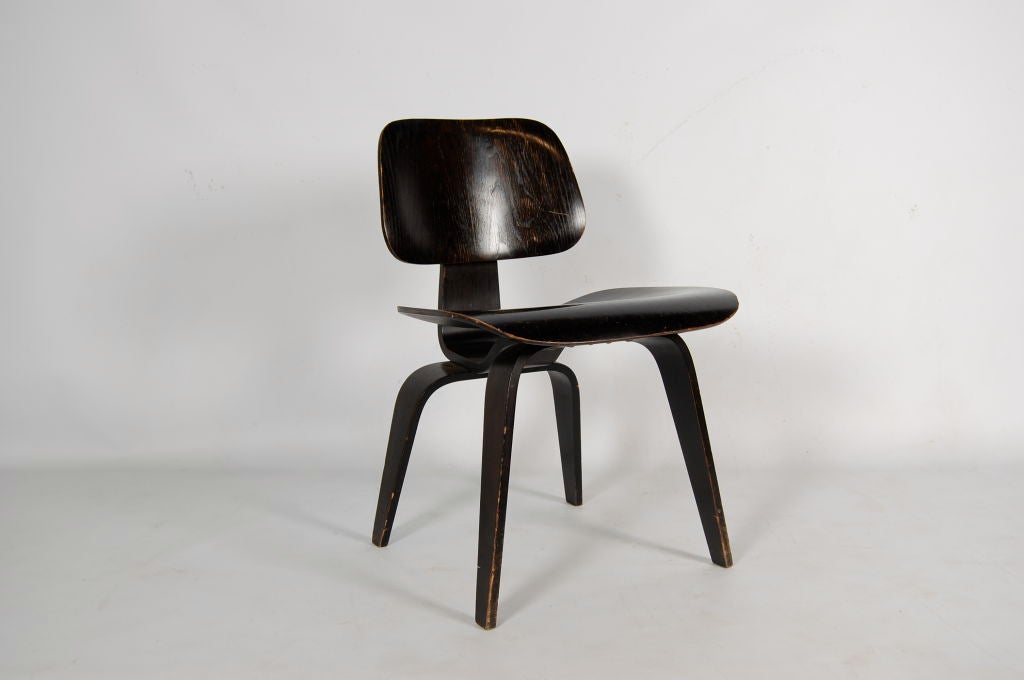Charles and Ray Eames for Evans Products Company , a DCW ( Dining Chair Wood ) , moulded plywood with black analine dye finish . This example is in stunning condition with no scratches , chips or repairs , finish looks to be original . The chair is