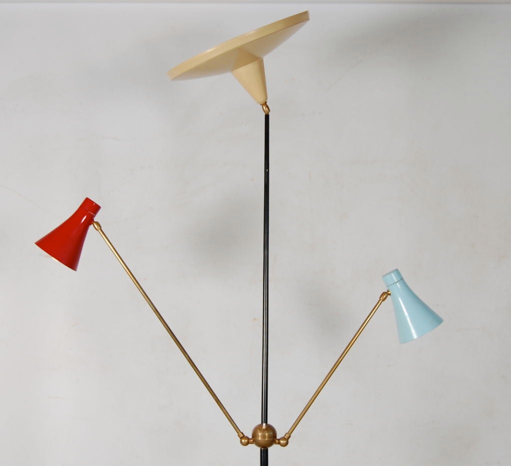 Stunning Stilnovo floor lamp which operates as an uplighter and downlighter . Marble base , two arms of differing lengths , both fully adjustable terminating in red and blue shades which also articulate . Central brass ball divides the stem and