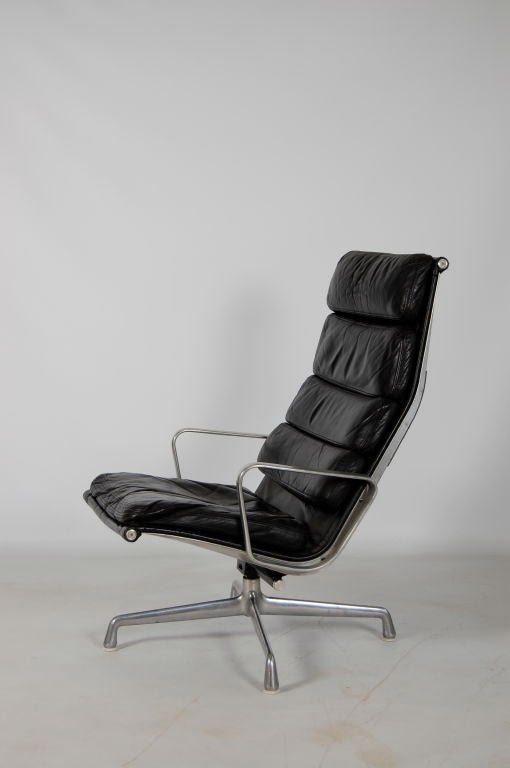 Charles Eames for Herman Miller , a 4 section high backed Soft Pad lounger with nicely aged black leather , aluminium arms and early 4 star steel base . Swivel , tilt and tilt adjustment .