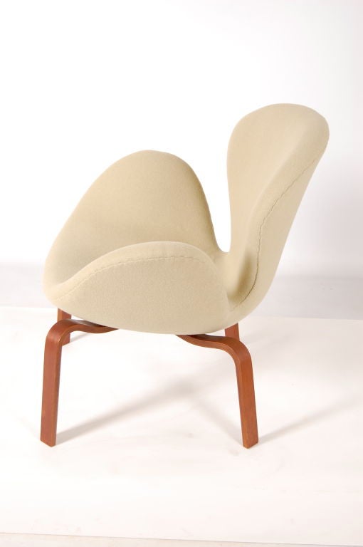 Arne Jacobsen for Fritz Hansen , Denmark . A rare Swan chair with wooden legs , produced in small numbers , this one is from March 1966 . Refoamed and reupholstered in soft beige Kvadrat Tonus fabric .