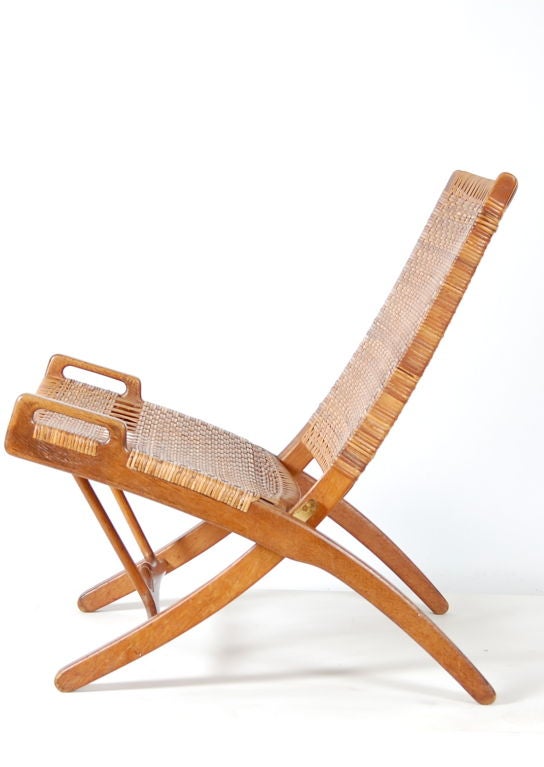 Designed by Hans Wegner for the cabinet makers exhibition in 1949 this folding chair is the first of a series of variants developed by Wegner and made by cabinetmaker, Johannes Hansen. It was designed to fold away and hang on the wall - hence the