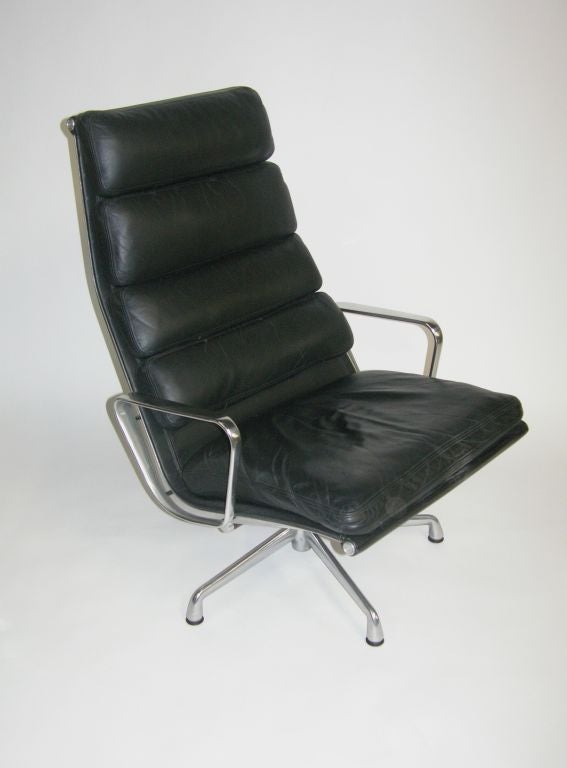 A handsome lounge chair in black leather with a polished aluminum frame. The chair tilts and swivels.  The condition is excellent overall.<br />
This item is located in our New York Location.