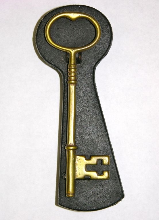 Key Shaped Door Knocker designed by Evelyn Jahncke.  
This functional door knocker is made of cast iron and brass.  
Signed in the casting,  Evelyn Jahncke, 1948. Reminiscent of the designs of Carl Aubock.