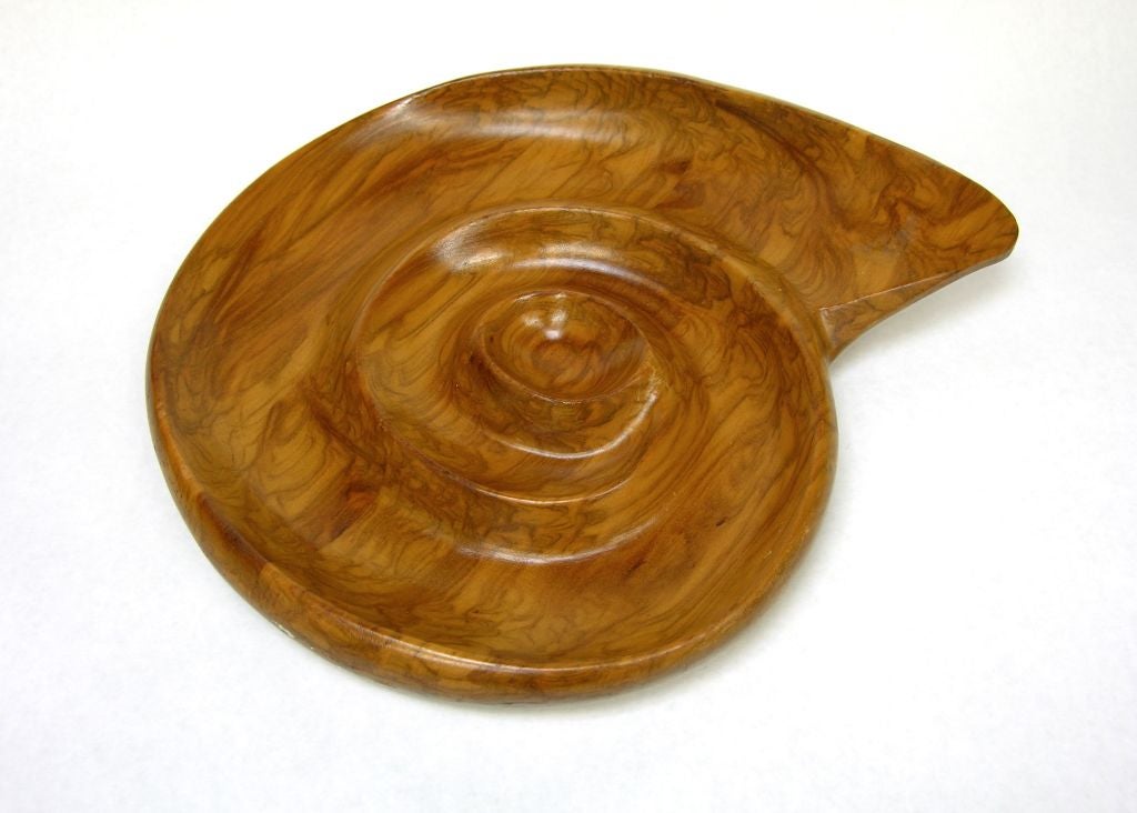 Snail shaped dish made of carved Maple. This piece is from a series called Oceana where Russel Wright called upon organic forms for inspiration.  These pieces were hand made by Klise Woodworking.
Branded signature to underside: [Russel Wright].