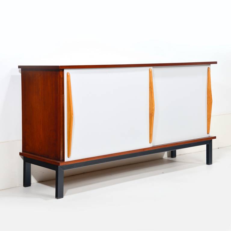 Sideboard designed by the famous French designer Charlotte Perriand (1903-1999) in walnut with black lacquered metal base and grey Formica door fronts. Edited by Steph Simon, circa 1958. Provenance: Cite Consado Mauritania, Africa.