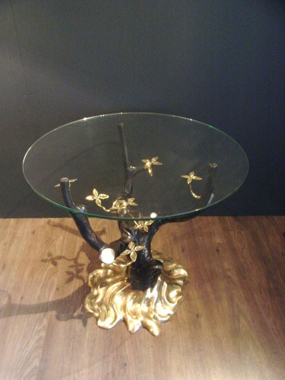 Patinated bronze decorative drinks table with glass top attributed to Willy Daro. Ideal for placement between two armchairs.
