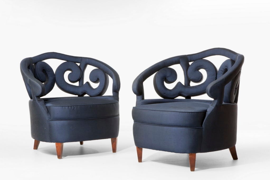 Pair of glamorous Italian armchairs with wooden legs and unusual decorative backs and sides. They were reupholstered in pure silk a few years ago.