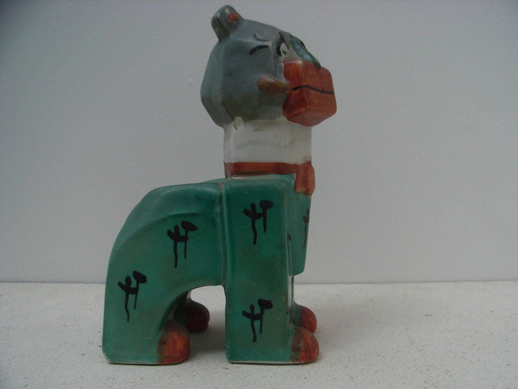 Cubist cat with black hieroglyphs on a green and blue body with red details  designed by Louis Wain.