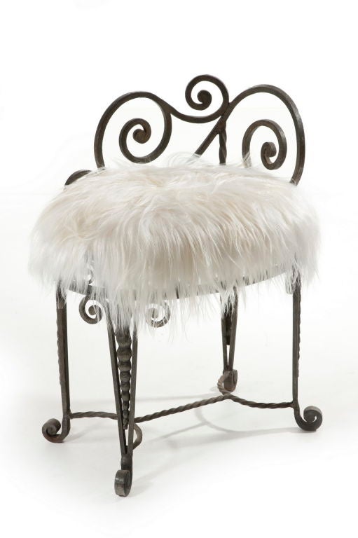 Good quality wrought iron stool with attractive scrolled design reupholstered in goatskin.