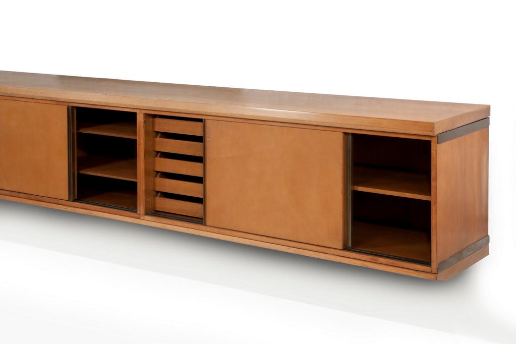 Long wall-mounted cabinet in teak designed by Osvaldo Borsani for Tecno, with original tan leather door fronts. The interior comprises shelves and drawers.



Provenance: Casa Franceschelli,Milan.