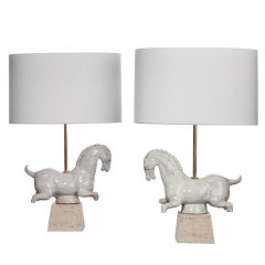Pair of ceramic table lamps with travertine bases.