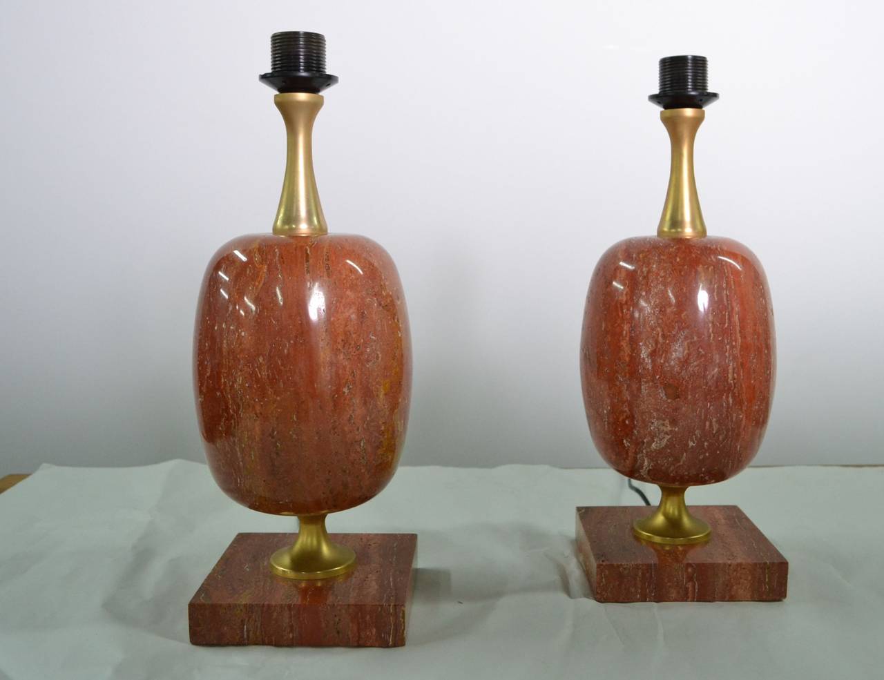 Pair of rose marble and lacquered brass table lamps
with new paper shades.