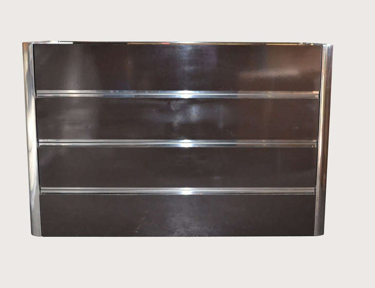 Brown melamine and chromed steel four drawer chest.