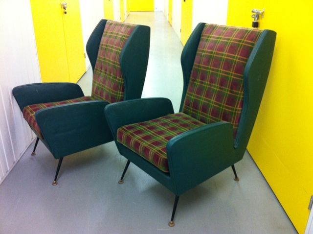 italian wing back armchairs in the manner of gio ponti with<br />
painted iron legs and lacquered brass feet , to be re-upholstered