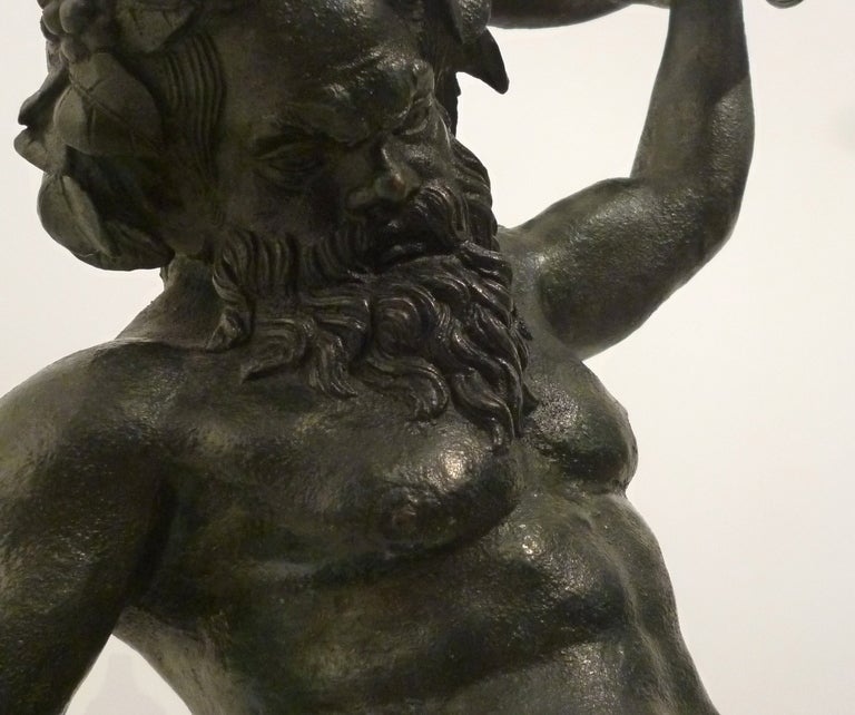 Italian bronze figure of Silenus by Chiurazzi of Naples circa 1910- after the original statue, discovered at Pompeii. In Greek mythology, Silenus was a companion and tutor to Dionysus, the God of Wine and festivals.The figure is shown on a circular