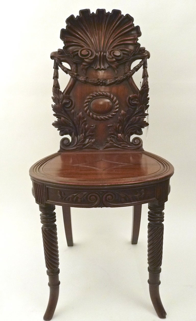 Very fine Irish highly carved Mahogany hall chairs with scallop shell backs circa1850.
The carved backs each with a beautiful scallop shell above festooned scrolled and foliate swags centred by a gadrooned cartouche over a solid seat with decorated