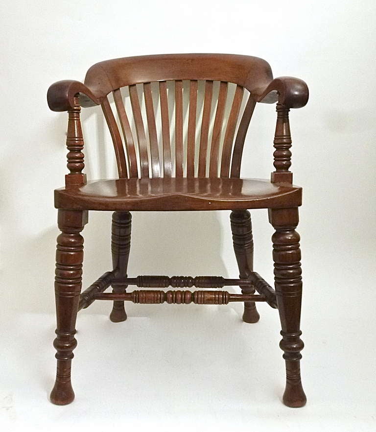 Set 6 very handsome and extremely comfortable English Victorian  mahogany slat back Windsor style armchairs. Each with a dished back above a slatted splat, on a solid shaped seat supported by spreading ring turned baluster legs with multiple