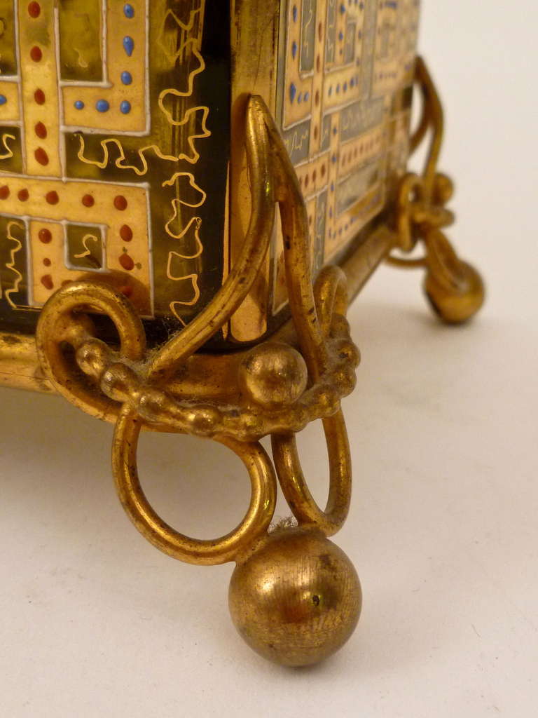 A rare and unusual pale amber glass casket, with geometric gilt overlay and beautifully enamelled floral decoration. The ornate mounts in gilt bronze. Bohemian c.1890.