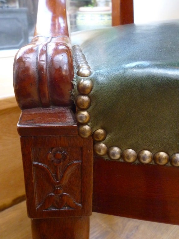 French Louis Philippe Mahogany Tub Shaped Desk Chair. 
The curved back terminating in lions head arm rests above a sprung, green leather seat on carved front legs with paw feet.