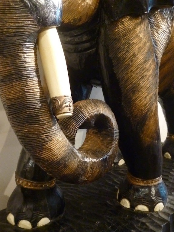 Large Pair of Indian Carved Wood Caparisoned Elephants with Gilt Gesso & Mirrored Ornamentation Simulating Lavish Jewellery. On integral carved wood oval plinths. The elephants are carved as a true pair as mirror images of each other. They were most
