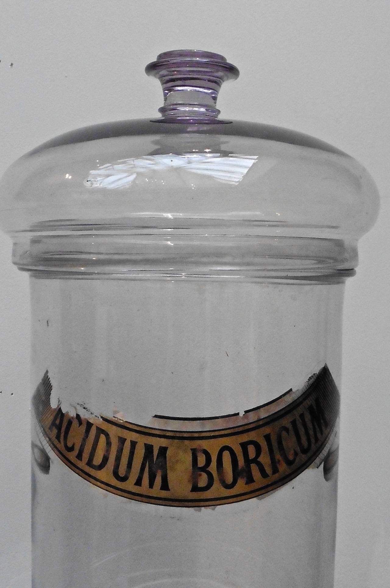 A wonderful pair of large French lavender tinted glass pharmacy jars and covers with original paper labels; one labeled 'Acidum Boricum,' the other 'Nux Vomica' circa 1860.