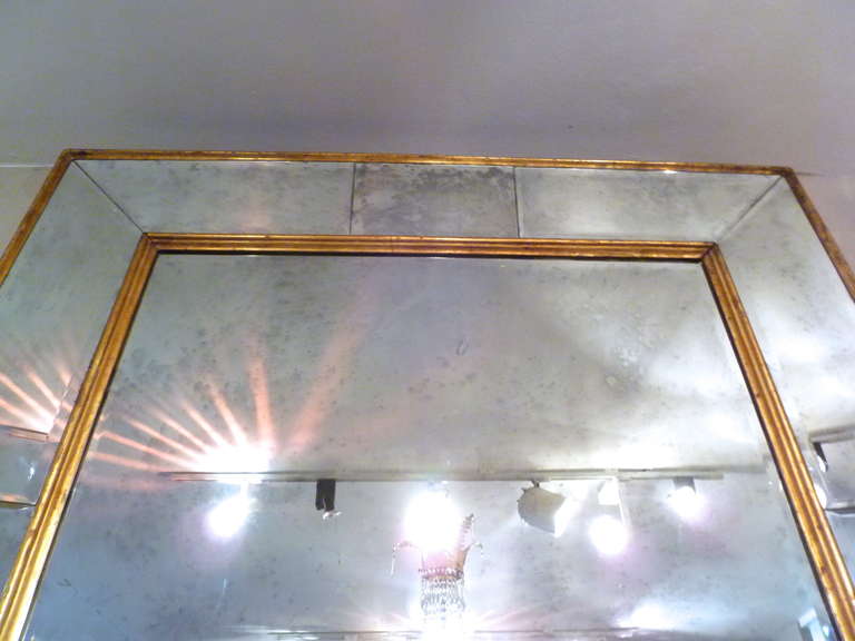A monumental Italian gilt wood framed mirror with partitioned and bevelled, mirrored border c.1940. Wonderful in either a traditional or contemporary interior.