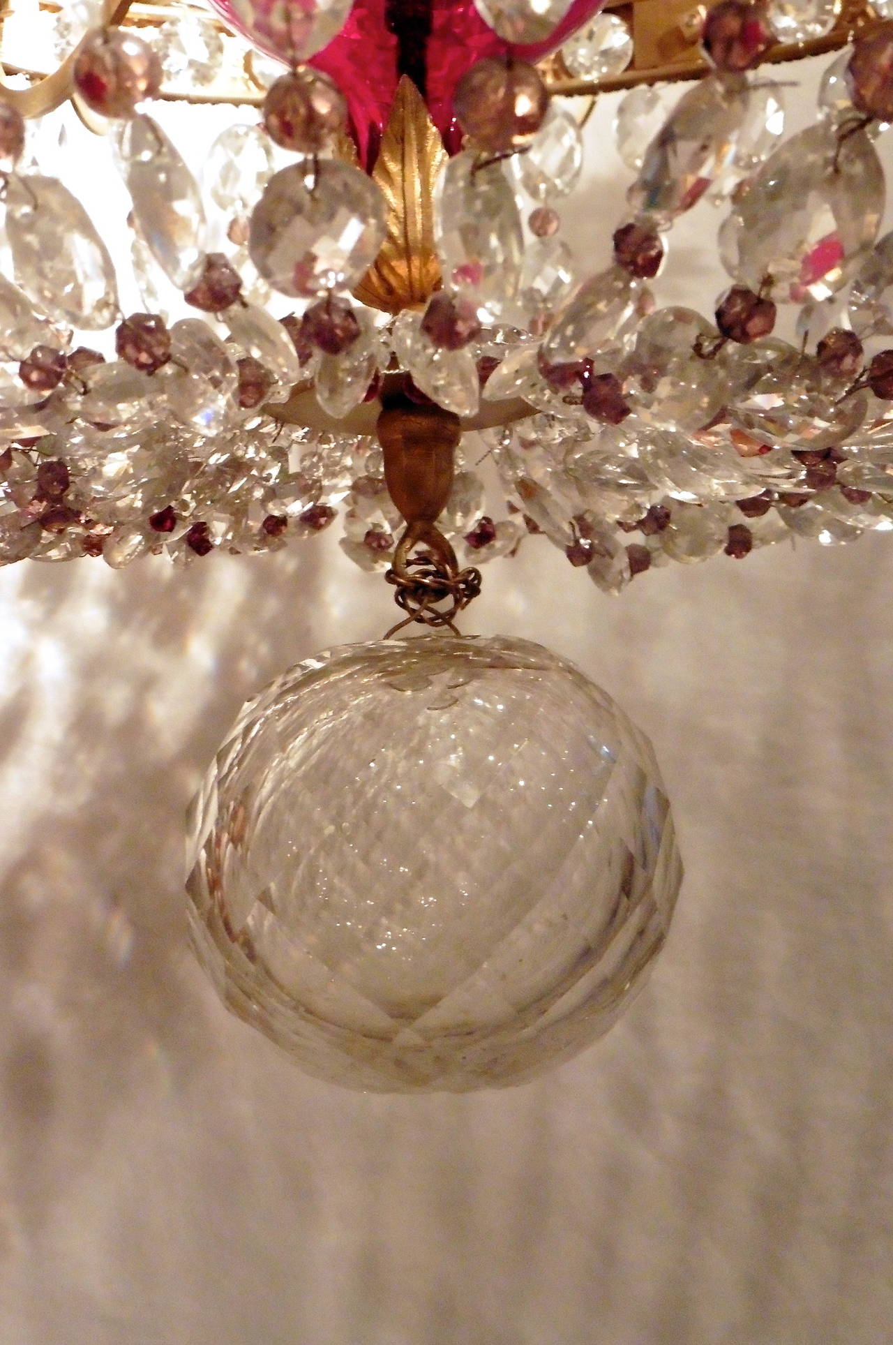 An extremely ornate Russian tent form twelve-light chandelier, circa 1780. The ruby glass central column with clear crystal drops and smaller colored beads richly adorned in gilt bronze. Adapted and with some later elements.