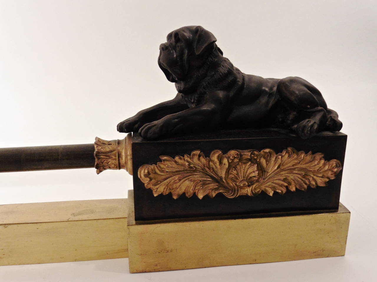 An extremely decorative French Empire neoclassical bronze and ormolu adjustable fender. With finely cast and chased reclining bulldogs at each end, and foliate ormolu mounts, circa 1820.
