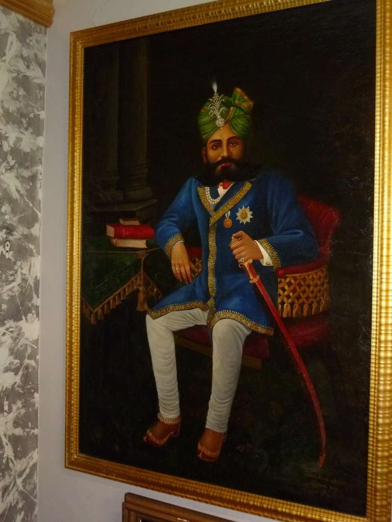 Decorative and large portrait of a seated Maharaja in traditional ceremonial dress. Oil on canvas signed Khoobchand Artist, Dewas 1909. In later frame.