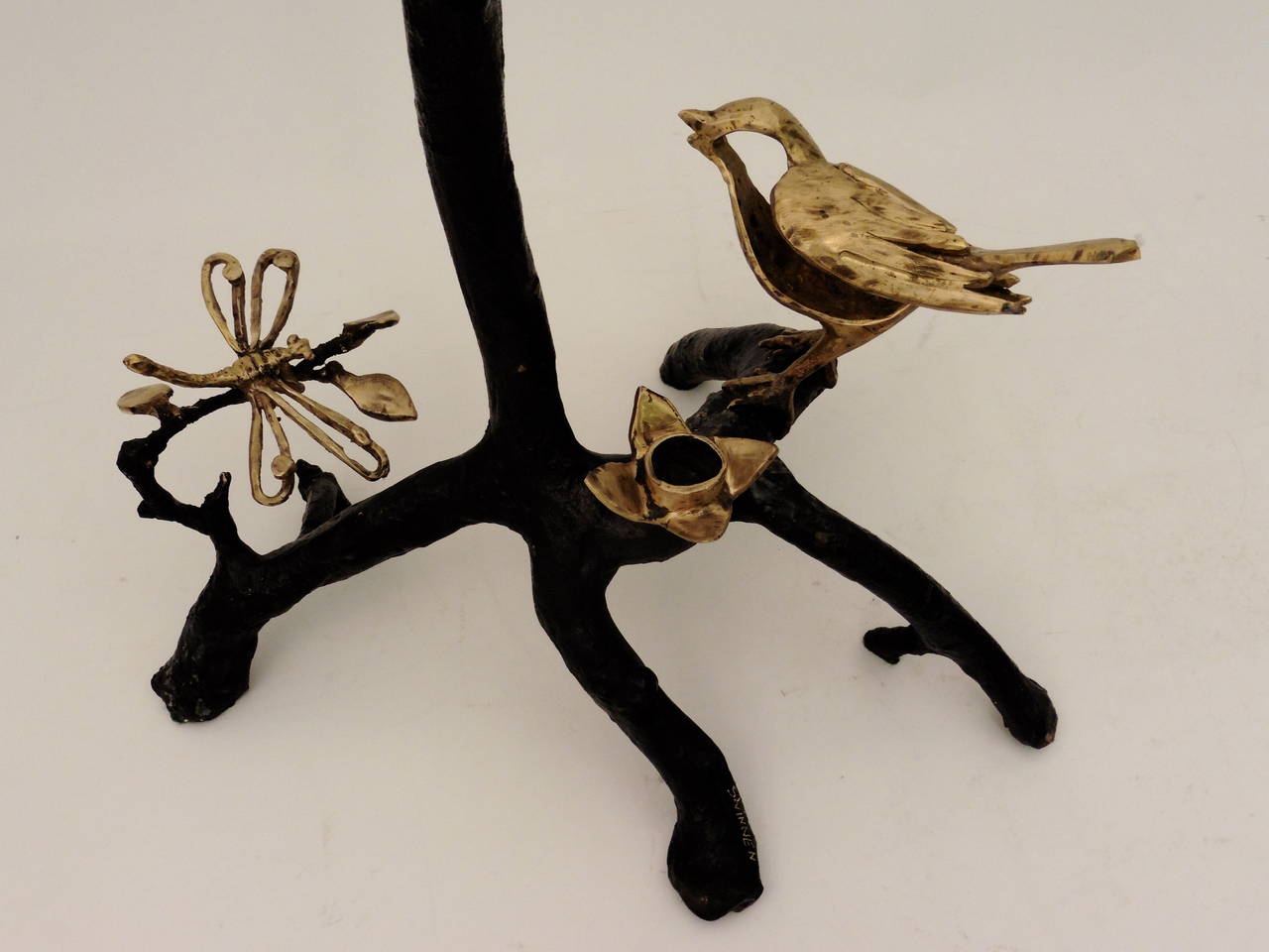 A joyous pair of patinated and polished bronze branch design candelabrum designed by Belgian artist, Paula Swinnen. Swinnen draws her inspiration from the natural world and works mostly in bronze but also uses shells and drift wood. These beautiful