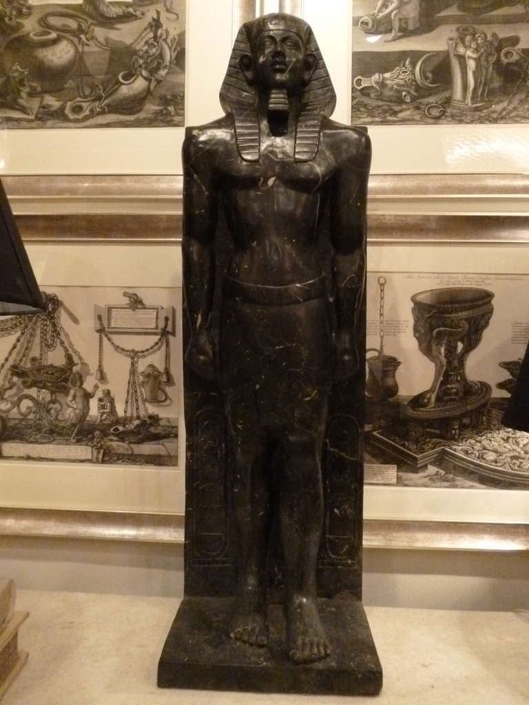 A handsome and well carved black marble Egyptian figure styled after the statue of Antinous depicted as the Egyptian God Osiris which was originally discovered in 1738-9 at Hadrian's Villa, and now resides at the Vatican.  It is similar to the