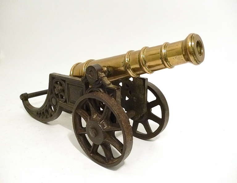 Pair Victorian brass ornamental cannons on cast iron carriages c.1880, with working wheels and handles. The heavy weight  carriages and fully tilting barrels finely and realistically decorated.