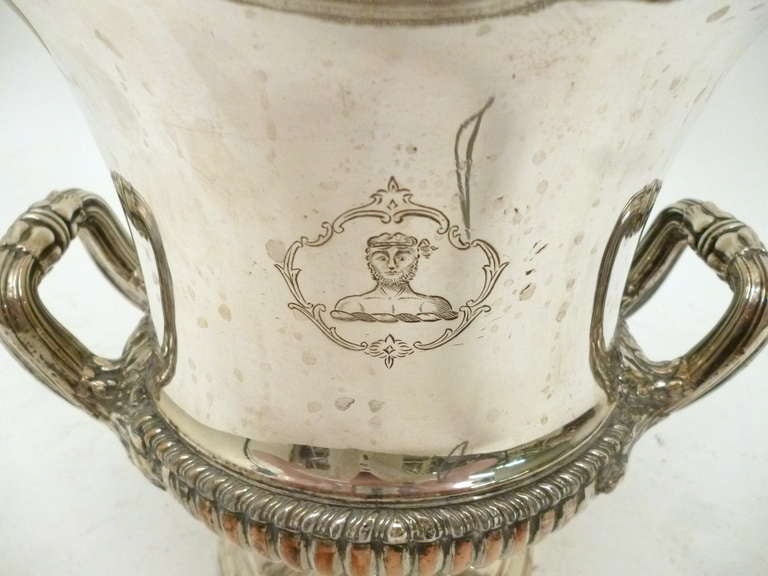 Elegant pair of late Regency Sheffield silver plate wine coolers  in a campana form by Matthew Boulton, with engraved family crests.  Raised on a stepped, circular foot, the gadrooned rim is interspersed with shell and acanthus leaf embellishments