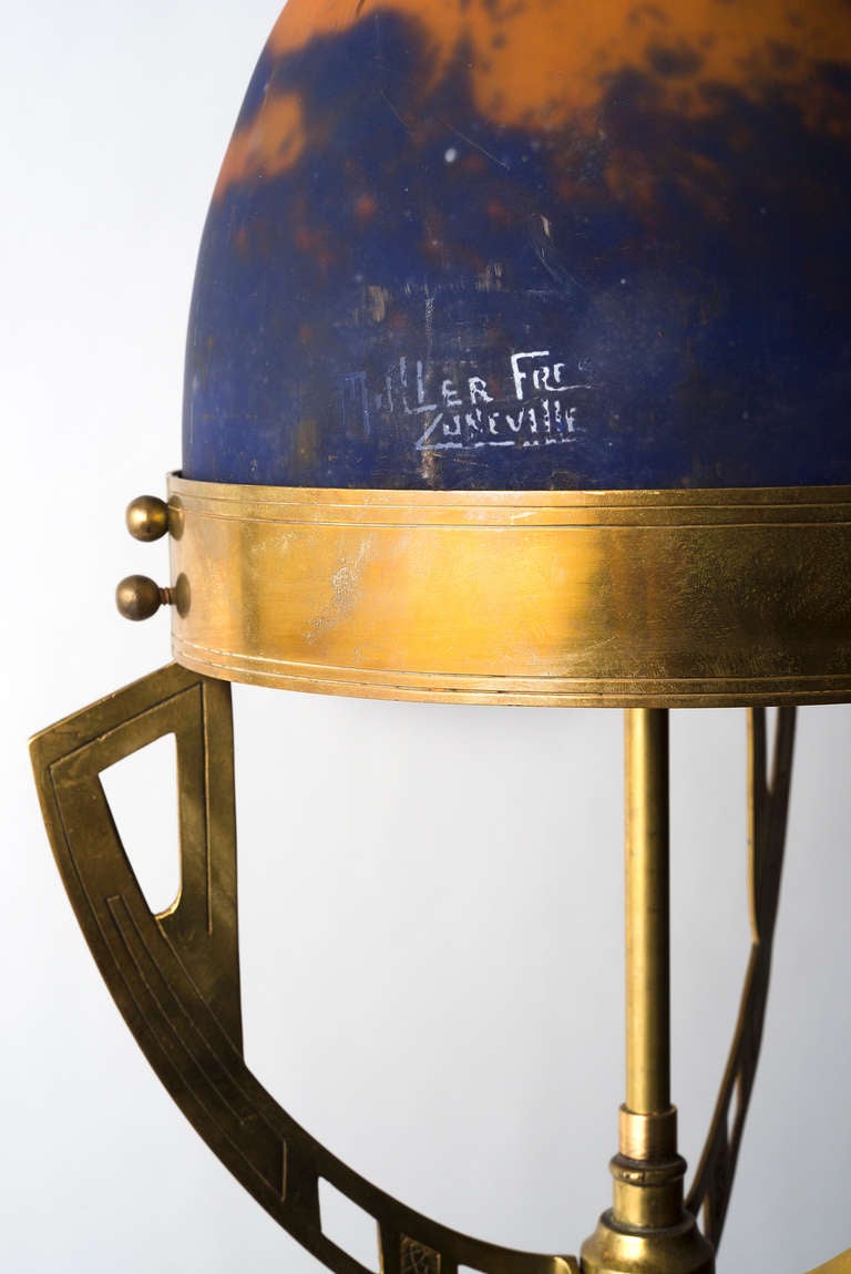 A rare and unusual French Art Nouveau brass lamp with a beautifully decorated glass domed top, in the form of a rocket. Signed Muller Freres. c.1910. Wired UK