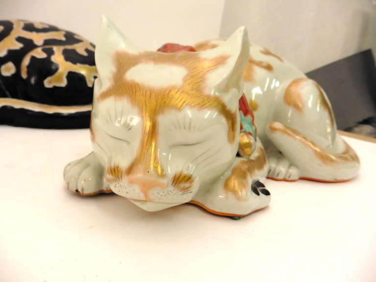 An adorable group of 5 Japanese Kutani Porcelain Cats - life size c.1900 - all 5 cats are realistically portrayed as curled up and asleep. 4 of them in white glaze with gilt highlights, the 5th cat is overpainted in black, also with gilt highlights.