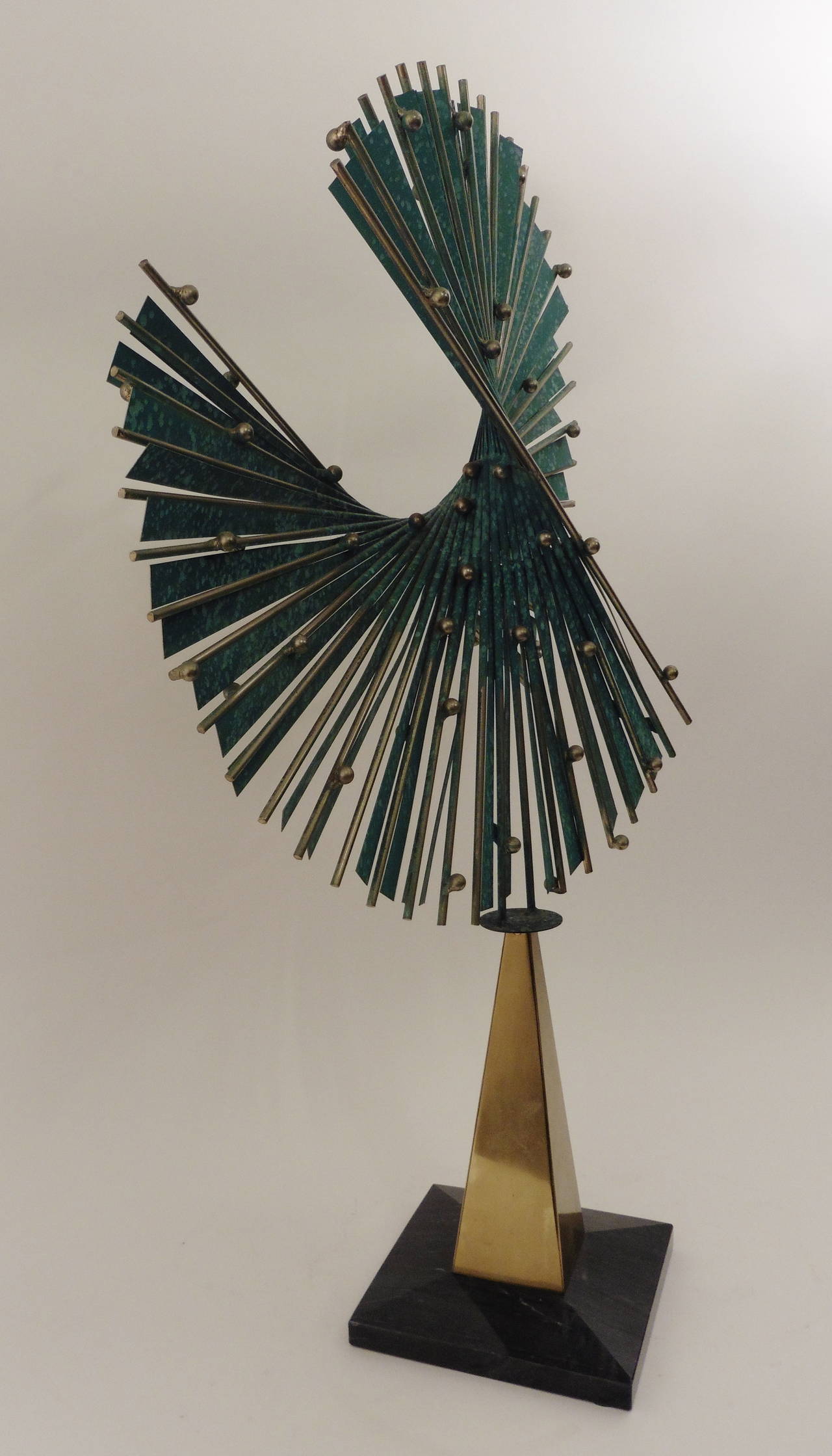 Sensational Curtis Jere sculpture in chrome and patinated bronze on a marble base, USA, circa 1985. The tall pyramid-like structure topped by a sea-blue fan consisting of chromed metal rods interspersed with patinated enameled metal strips and