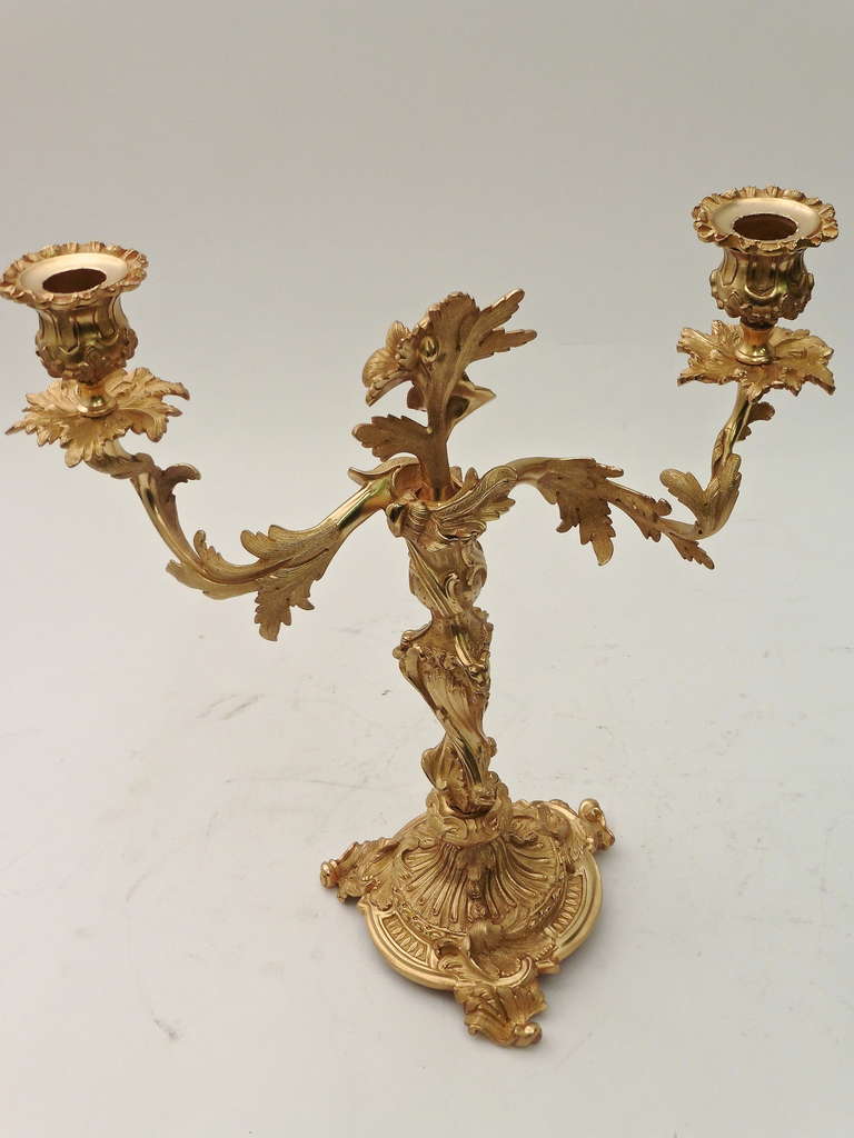 A delightful pair of French Rococo style twin branch ormolu candelabra c.1880. Finely cast and chased with floral and foliate decoration, supported by a gadrooned, circular base and acanthus feet.