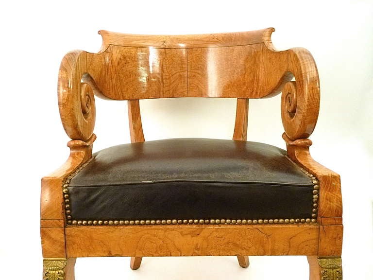A very fine French Charles X burr elm “Fauteuil de Bureau” desk chair c1830.
The curved backrail terminating in exaggerated scrolled armrests, above a patinated black leather seat, on square sabre front legs with finely cast and chased